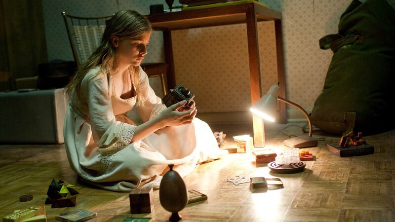 girl playing with puzzle on floor