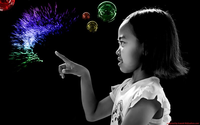 girl pointing at colorful lights