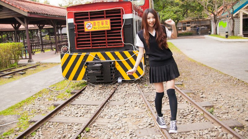 Girl posing on train tracks