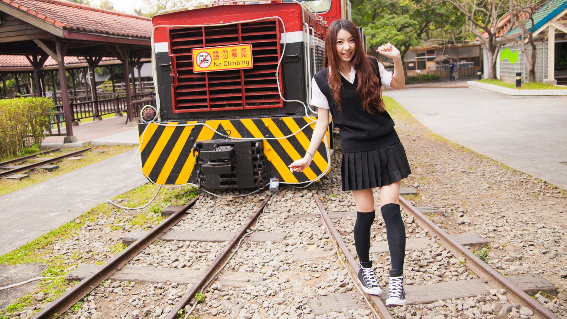 Girl posing on train tracks