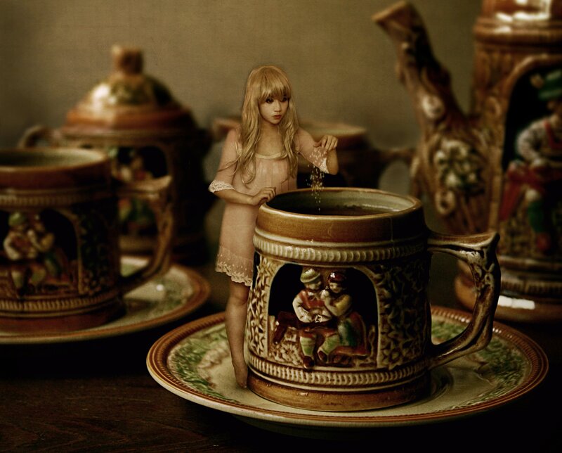 girl pouring sugar into a mug