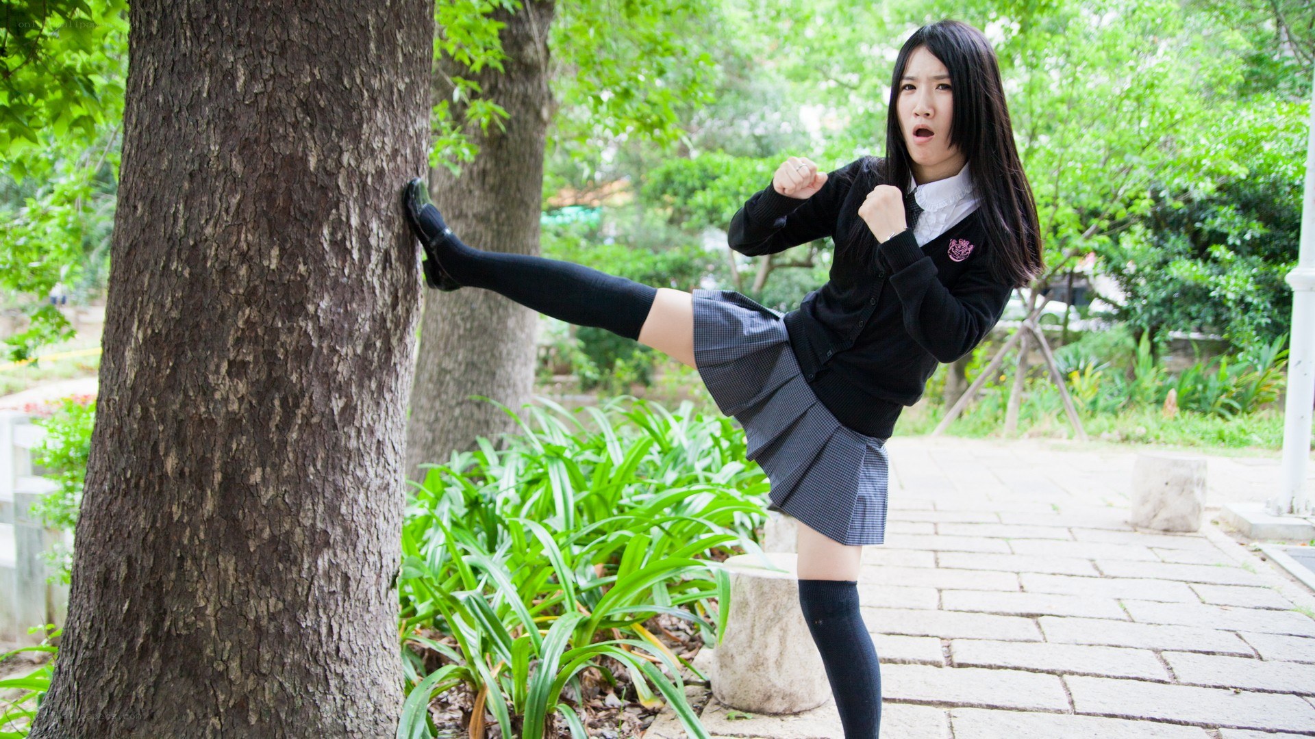 girl practicing kick in park