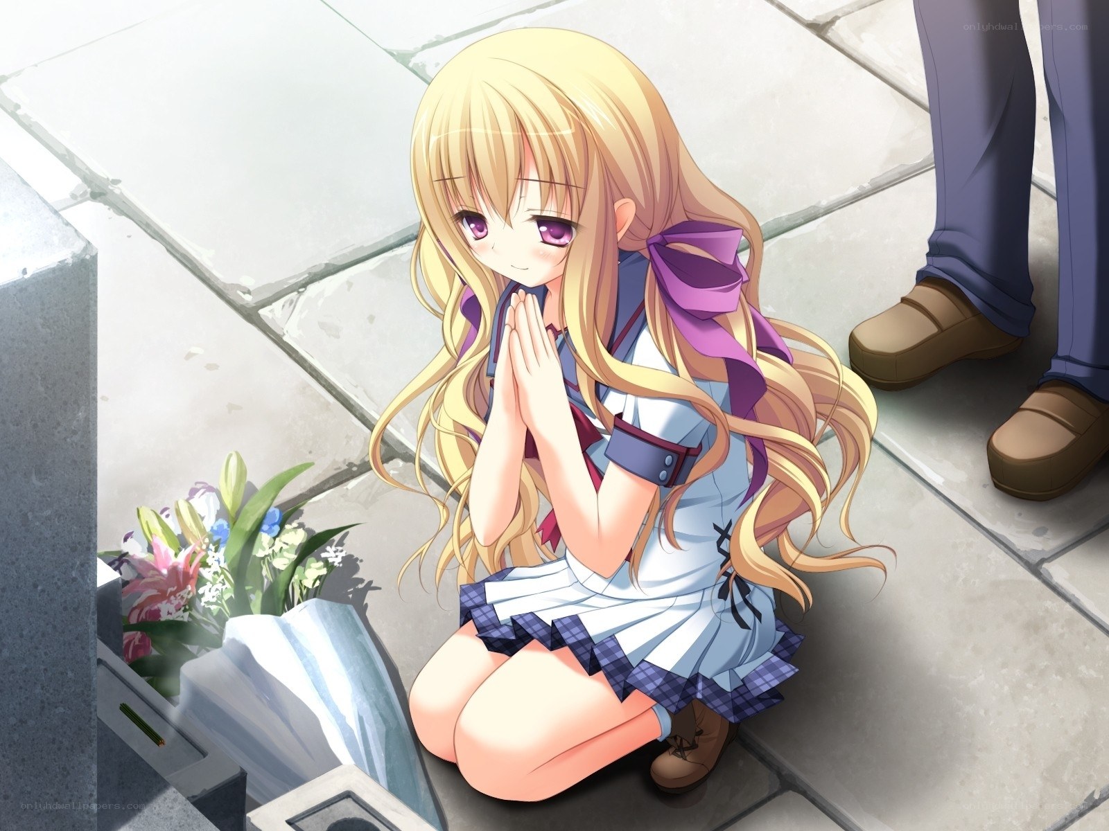 Girl praying at a grave