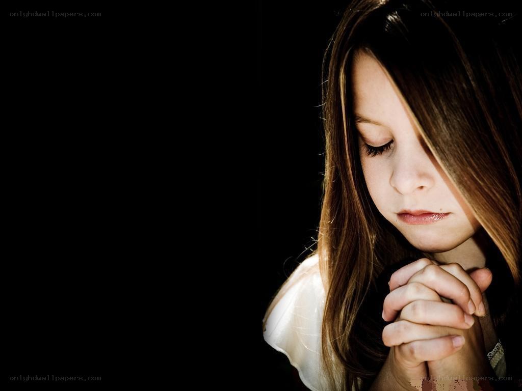 girl praying with hands clasped