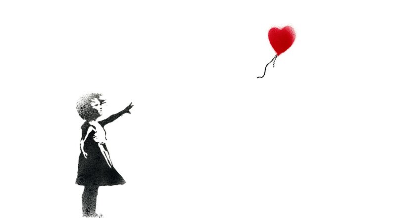 Girl reaching for heart balloon