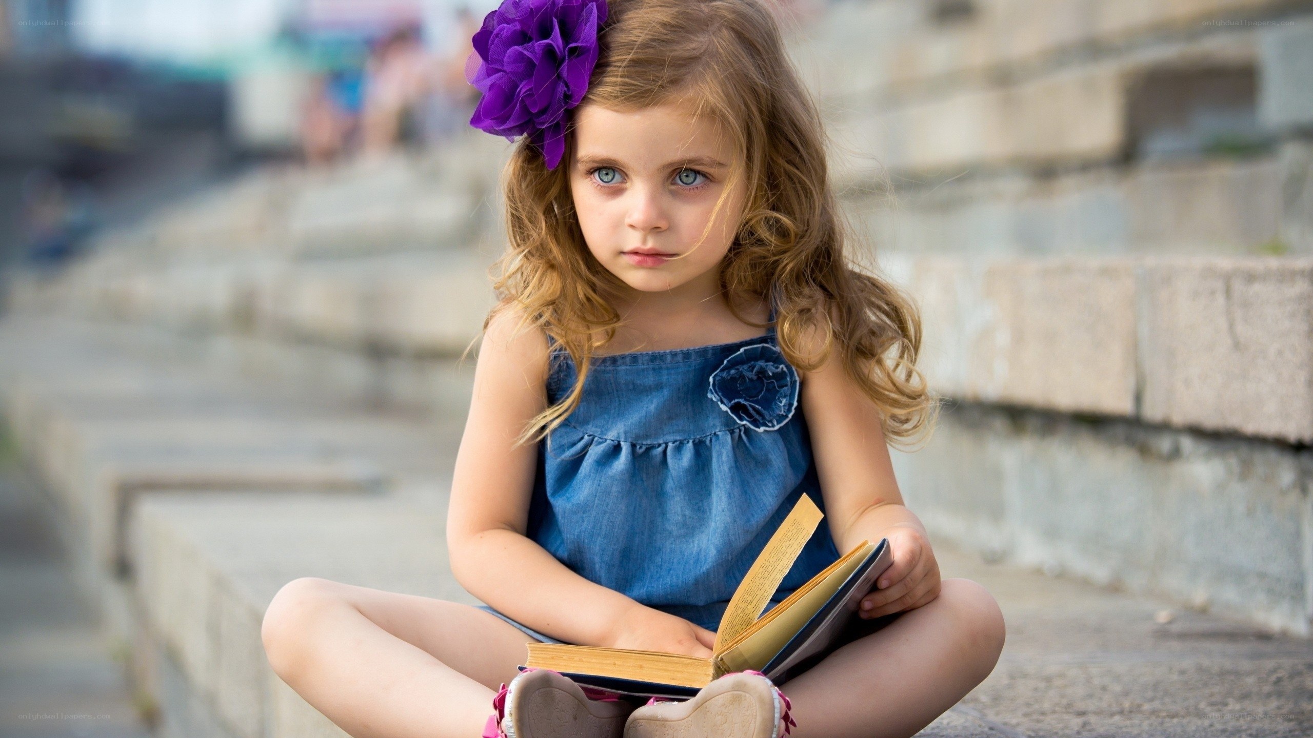 girl reading book on steps