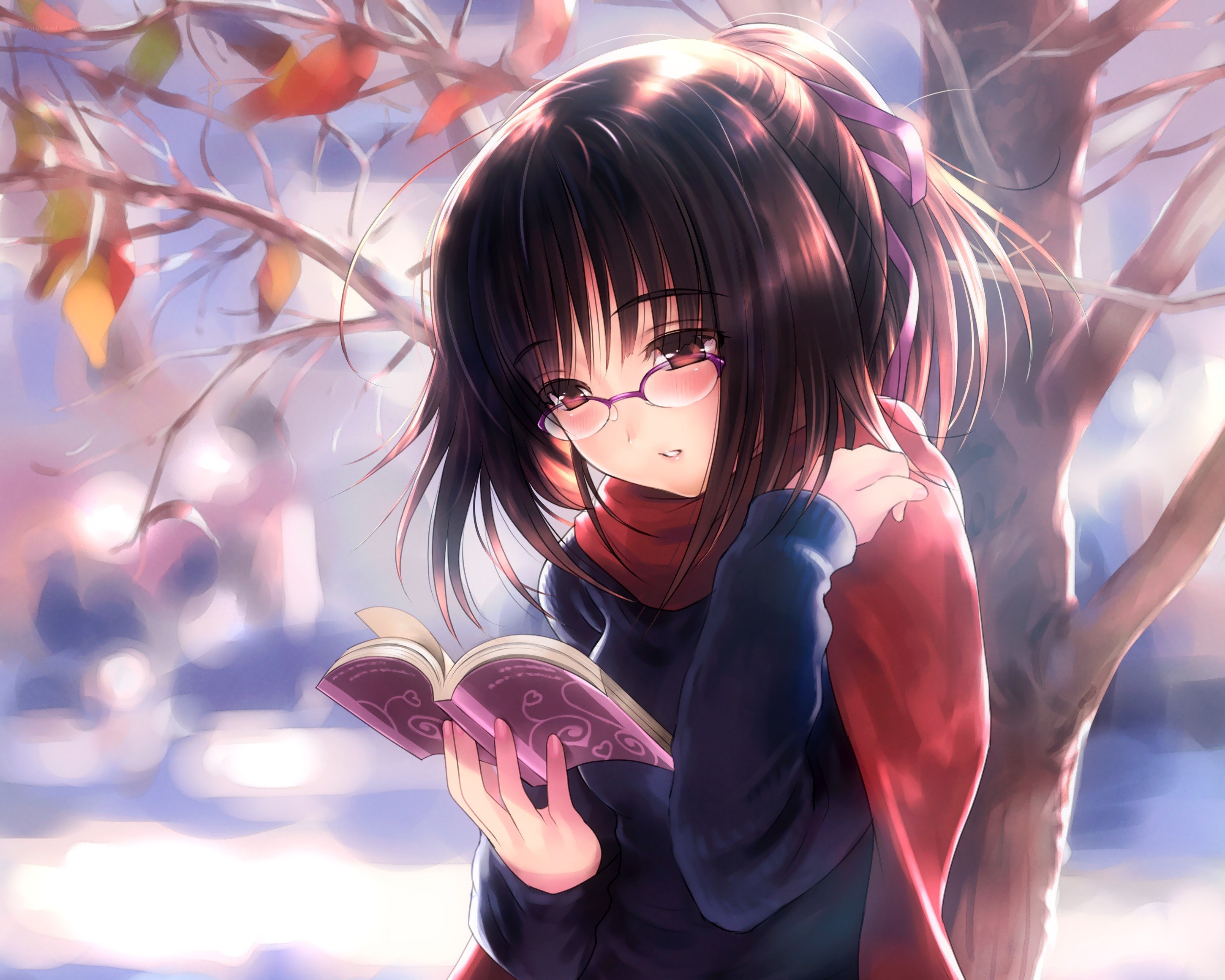 Girl reading book under tree