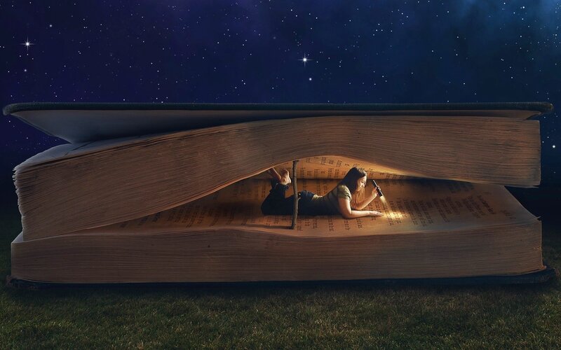Girl reading in giant book