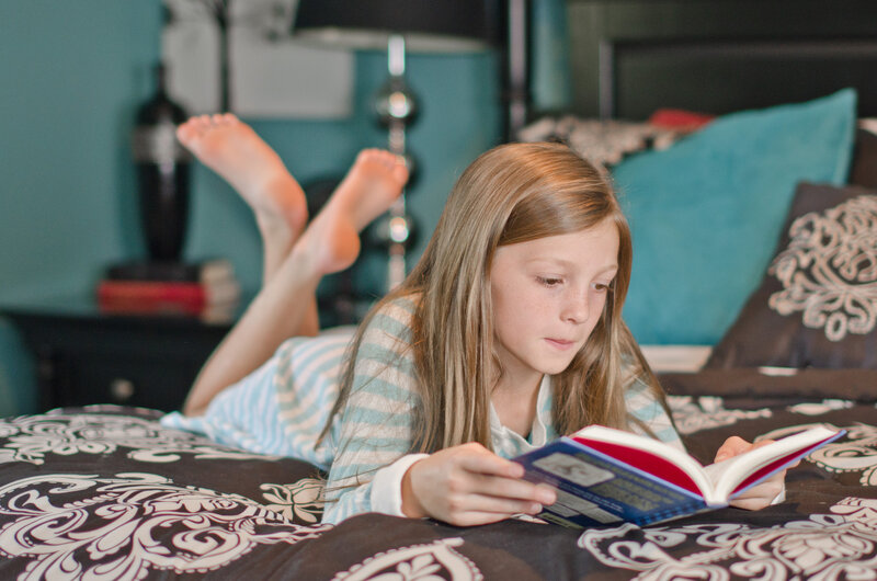 Girl Reading on Bed — Blue
