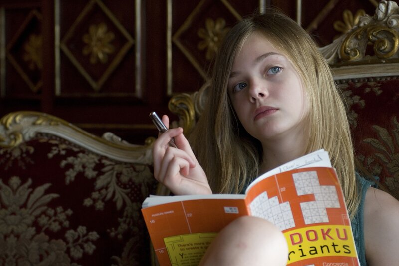 Girl reading puzzle book