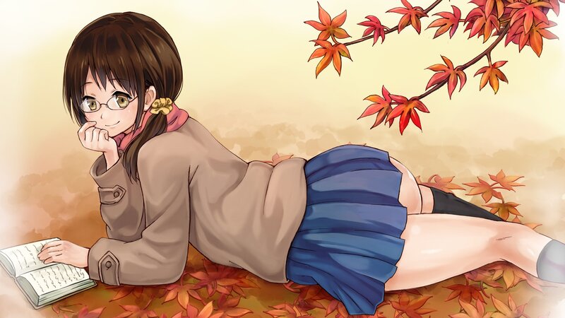 Girl reading under autumn leaves