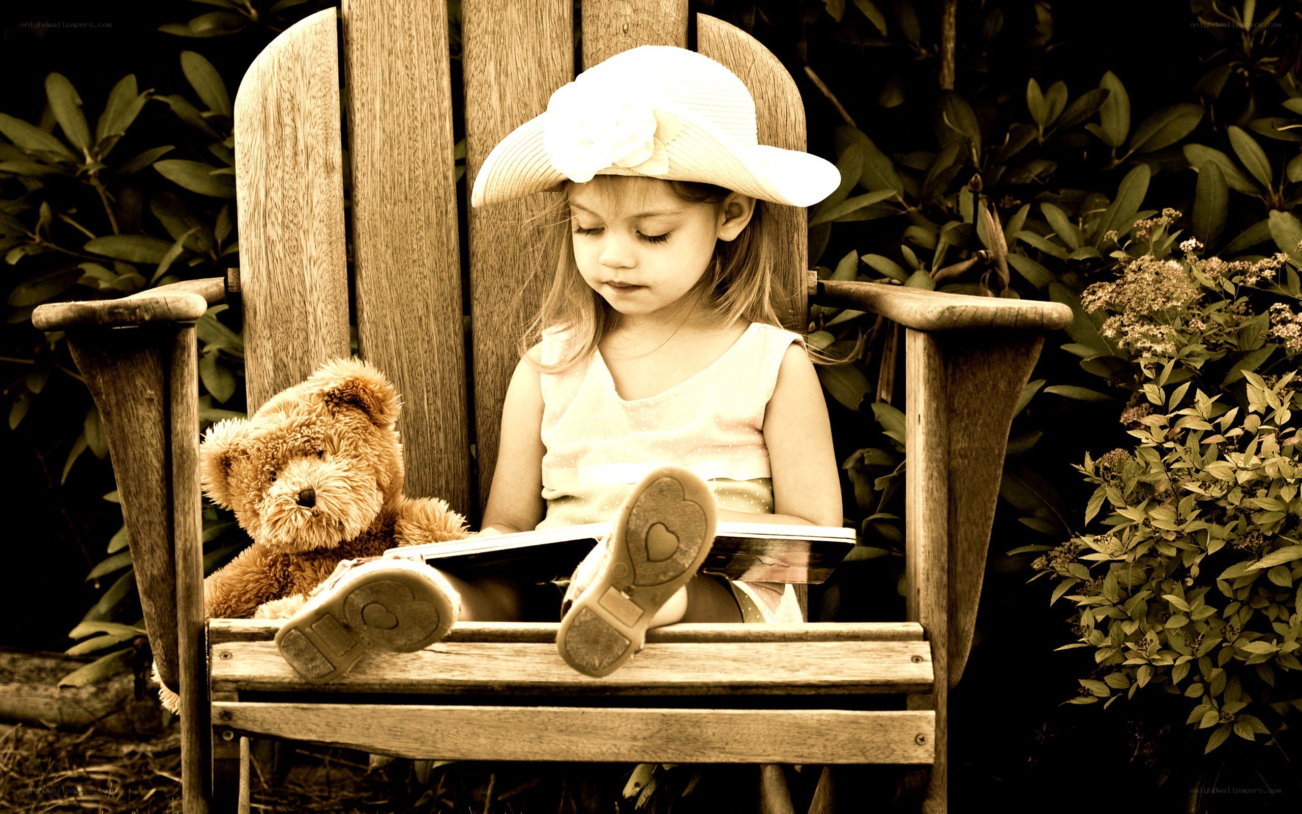 Girl reading with teddy bear