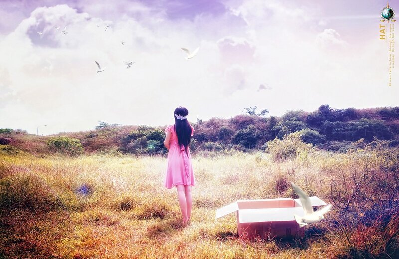 Girl releasing doves in a field