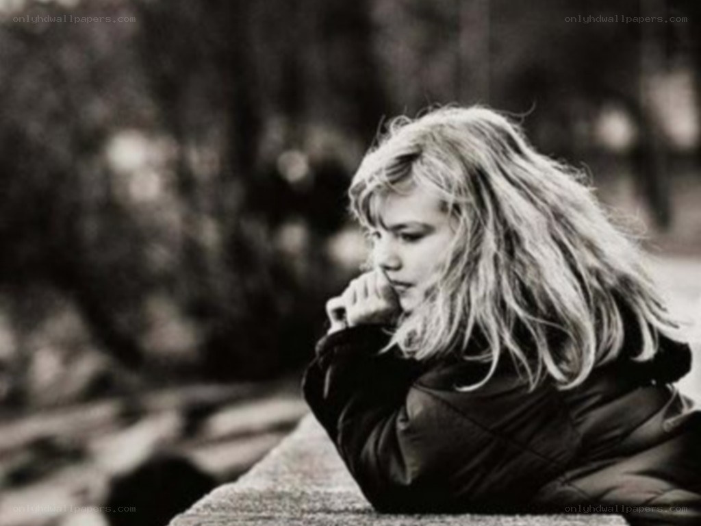 girl resting on a wall