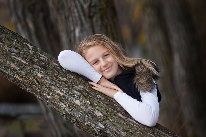 Girl Resting on Tree Branch — Brown