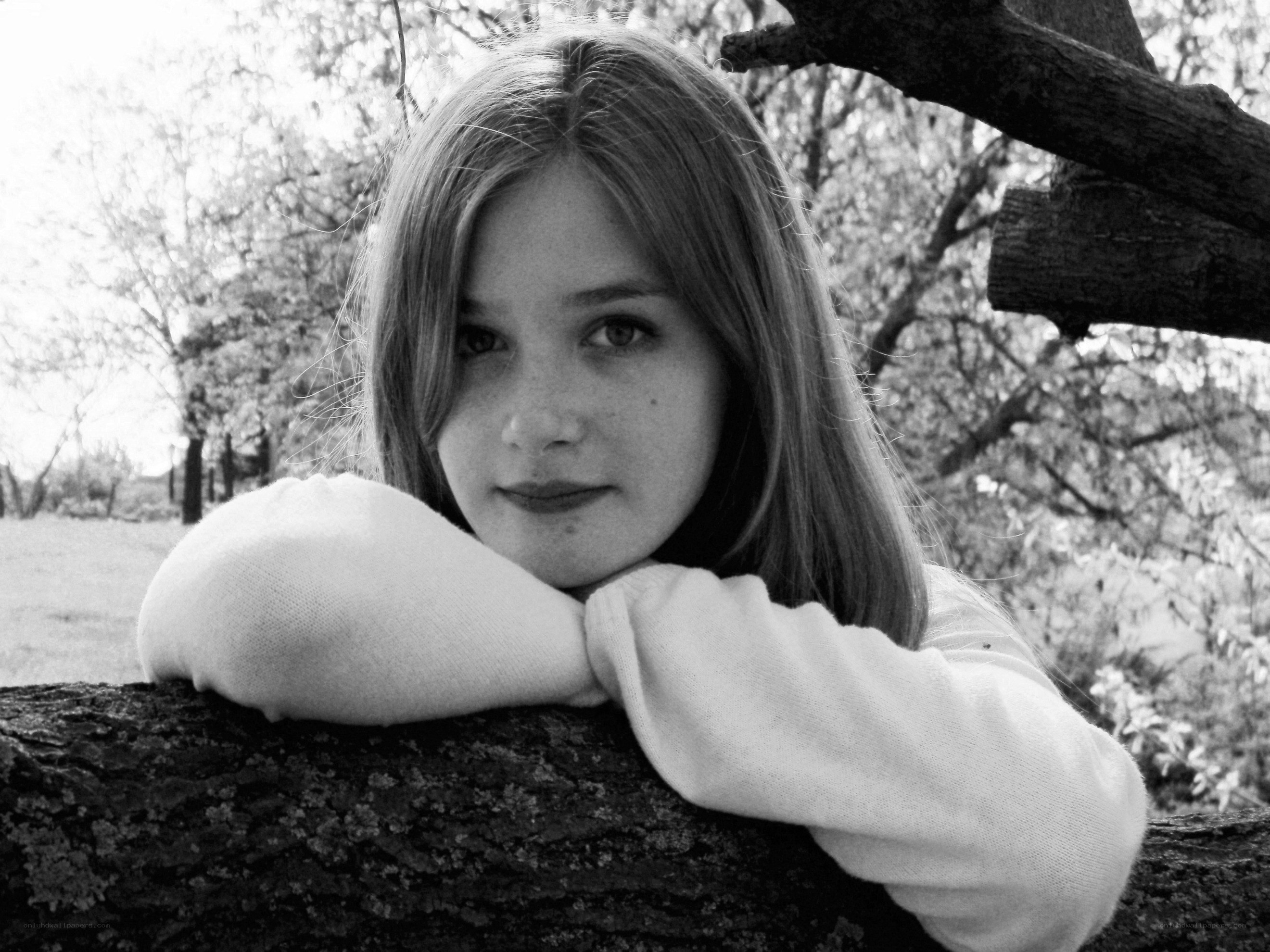 girl resting on tree branch