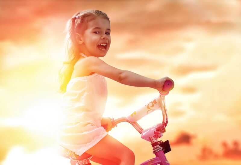 Girl Riding Bicycle — Orange