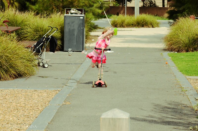 Girl riding scooter in park