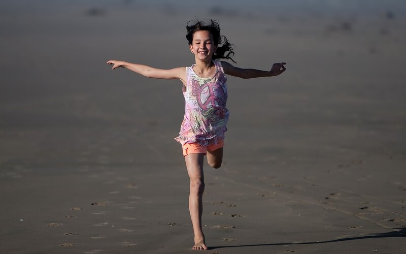 Girl Running on Beach — Brown, Playful