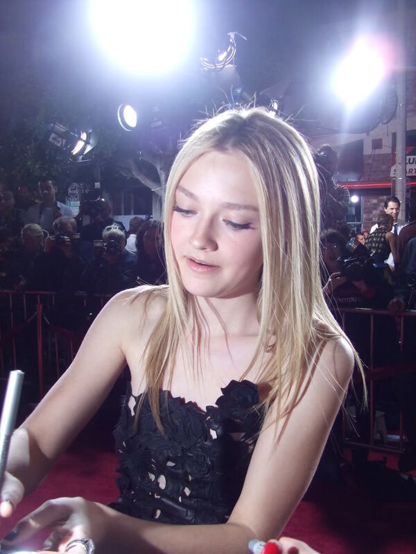 girl signing autograph on red carpet