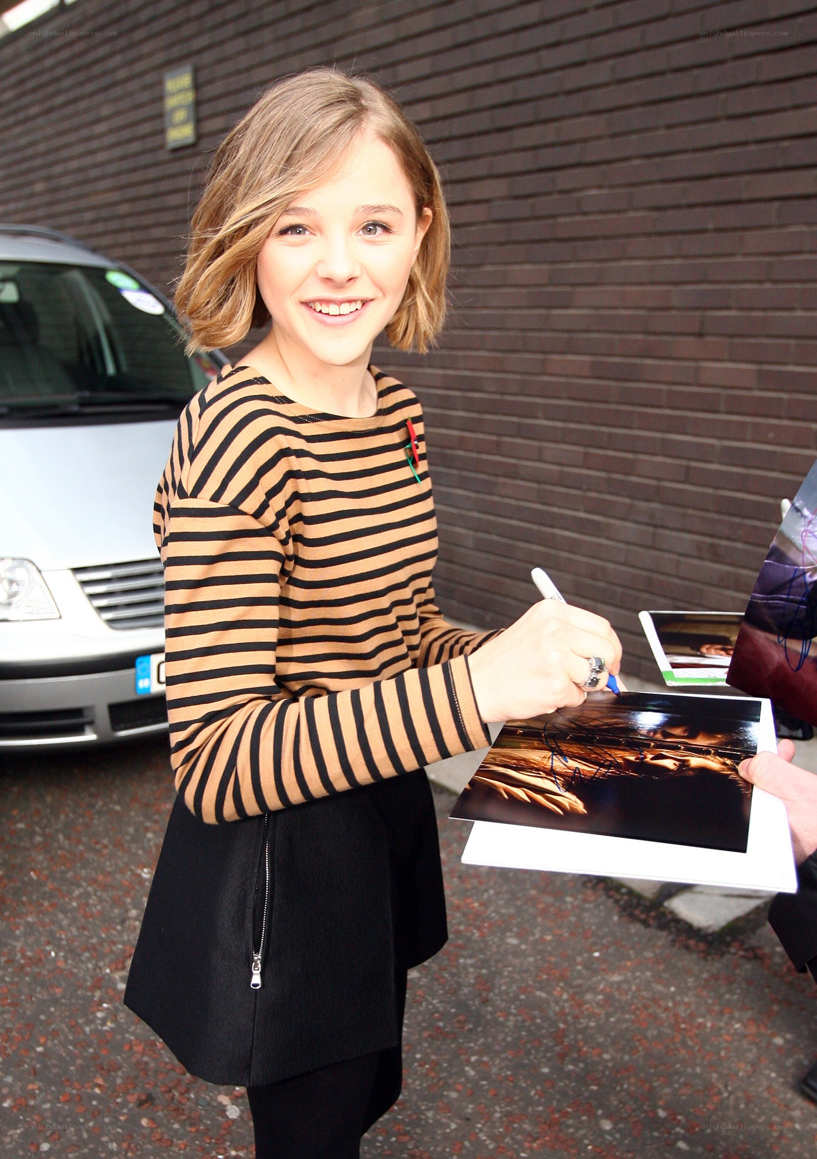 girl signing autograph