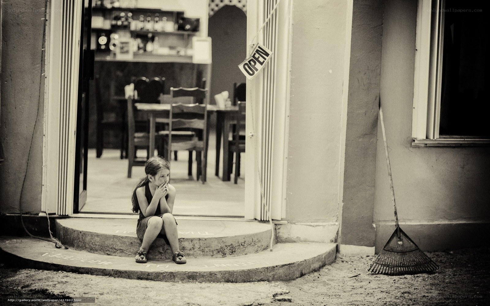 Girl sitting at doorway