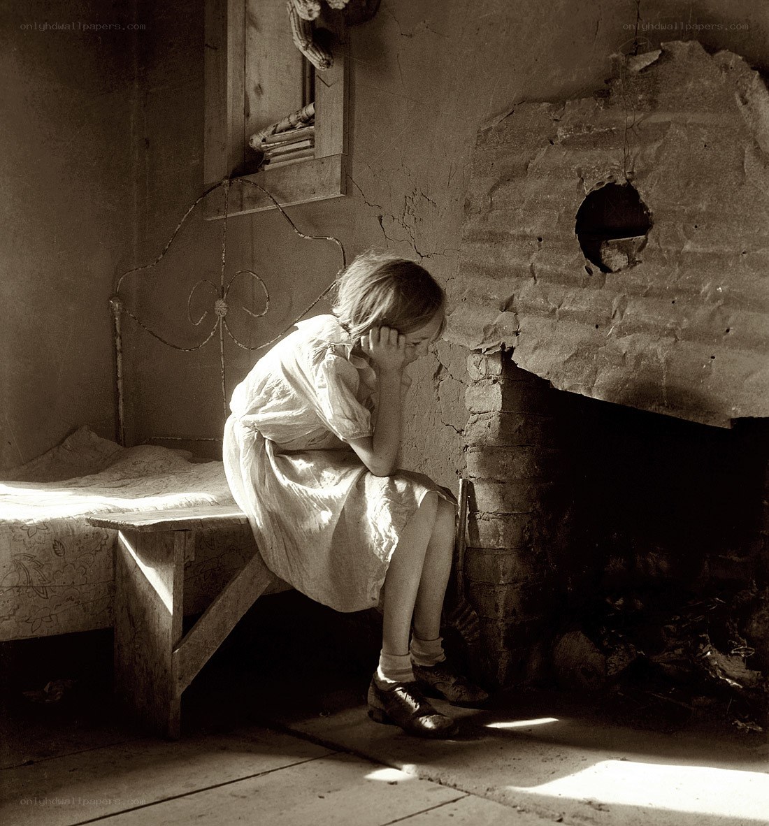 Girl sitting by a fireplace