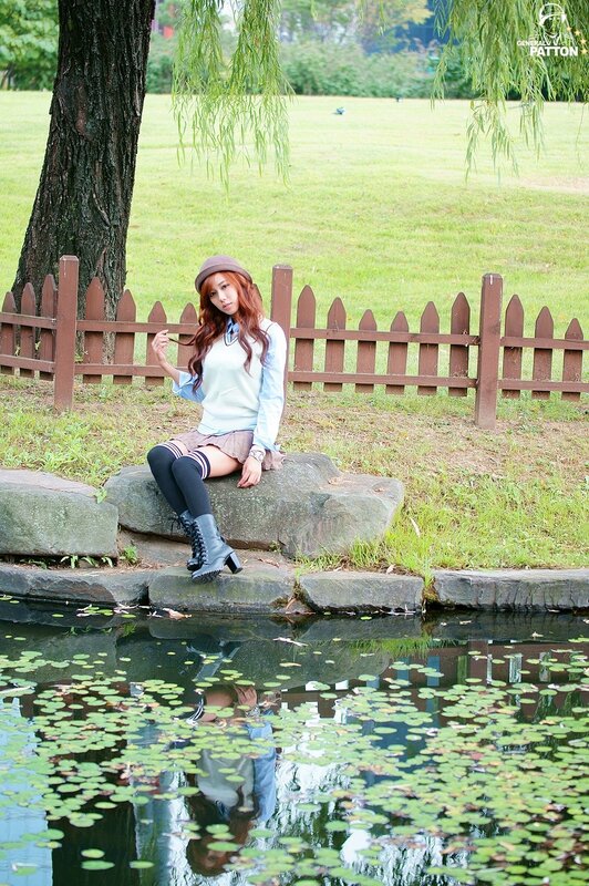 Girl sitting by a pond