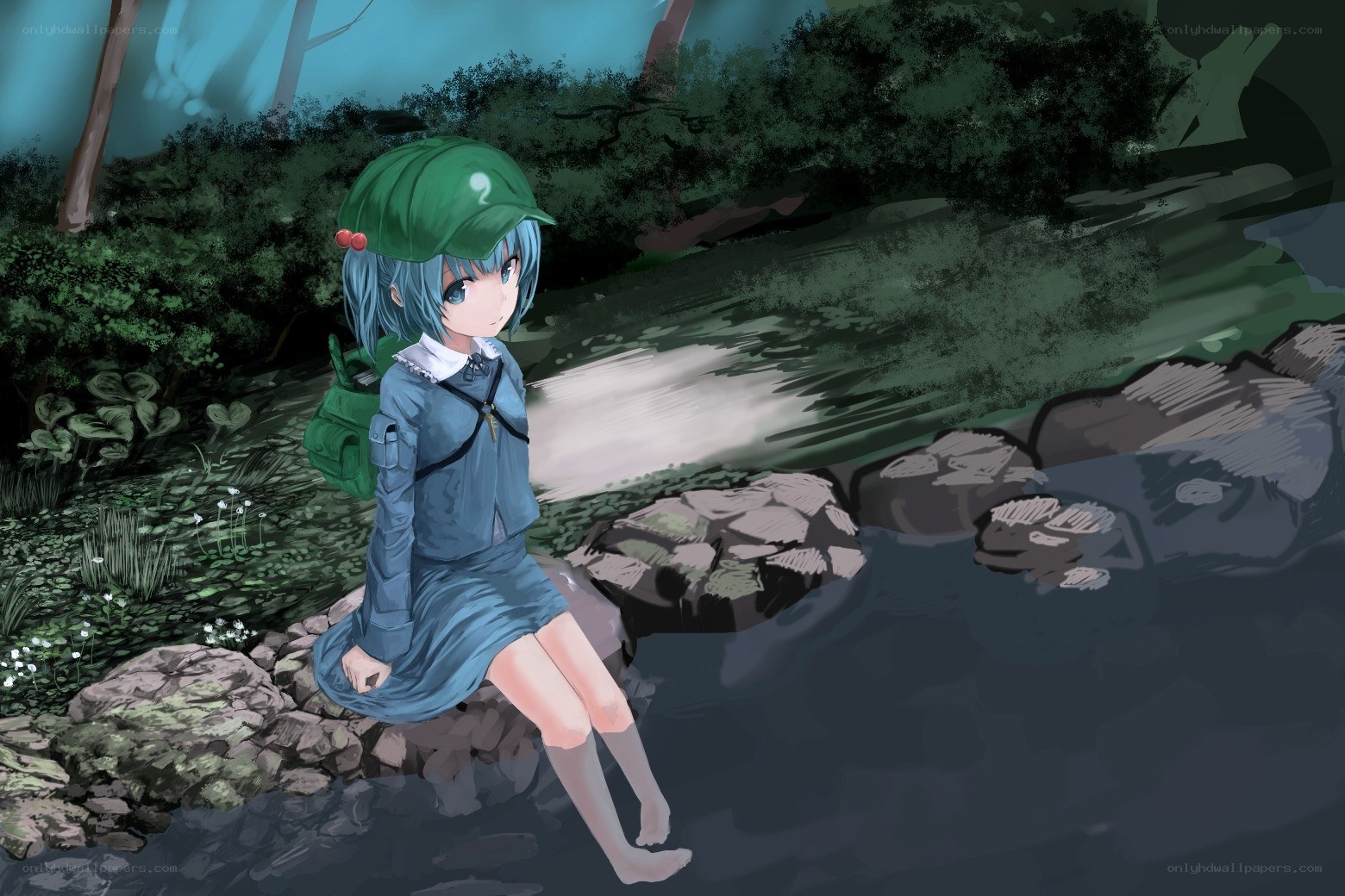 girl sitting by a stream