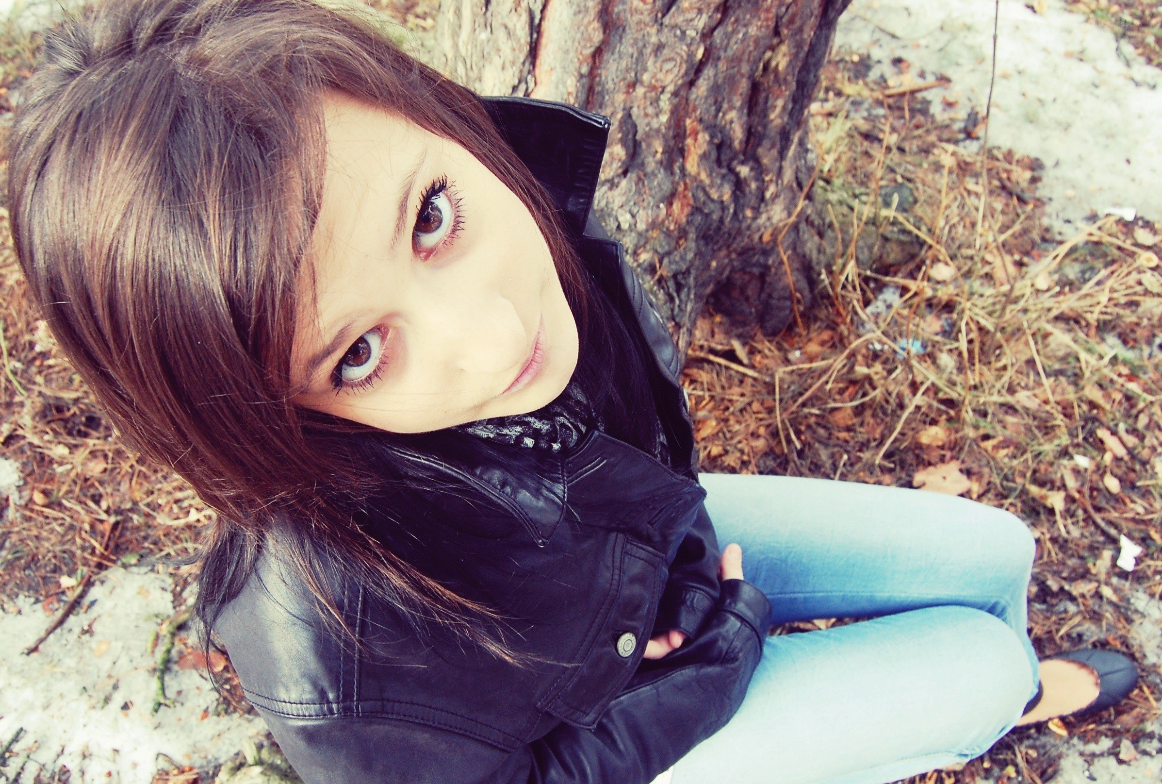 girl sitting by a tree