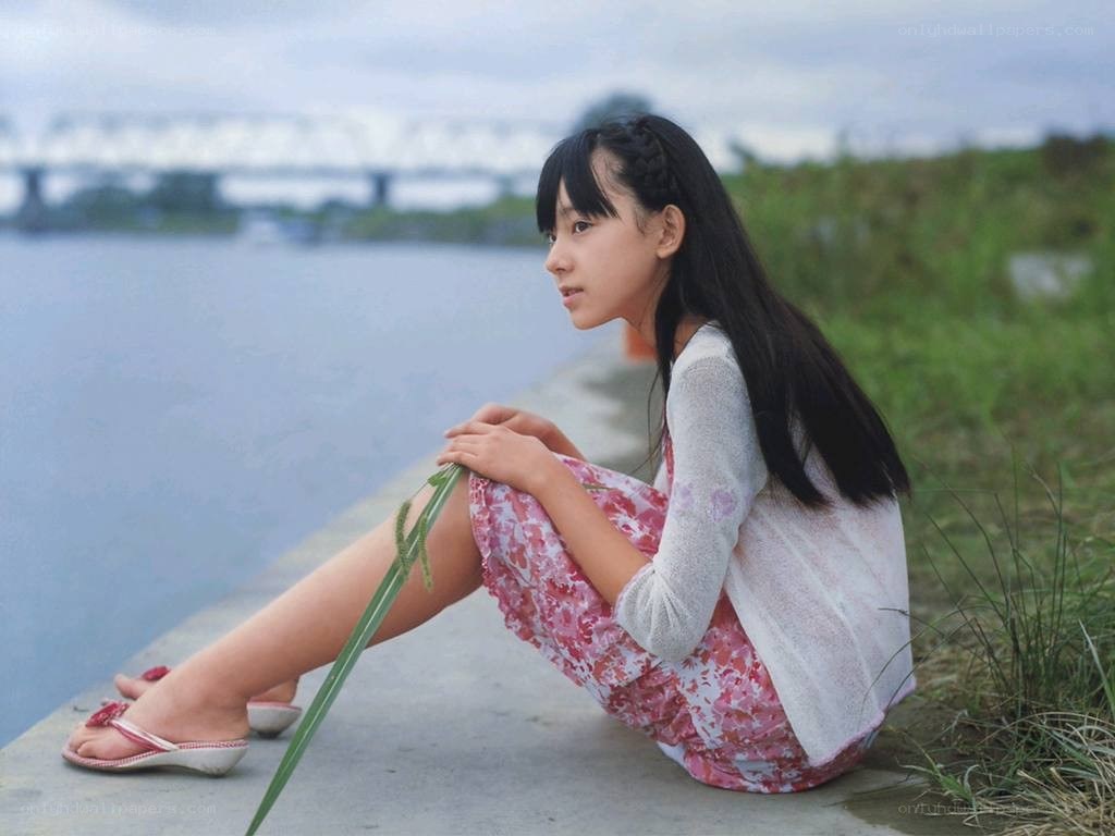 girl sitting by the river