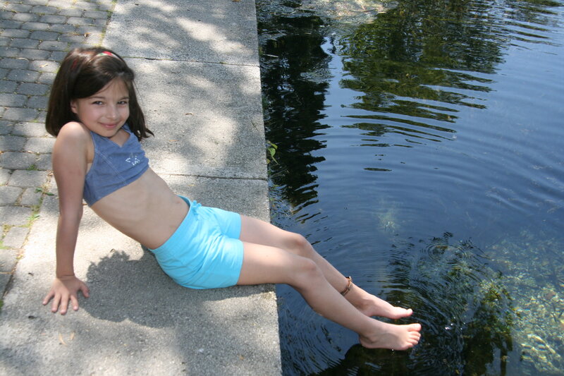 Girl Sitting by Water — Blue