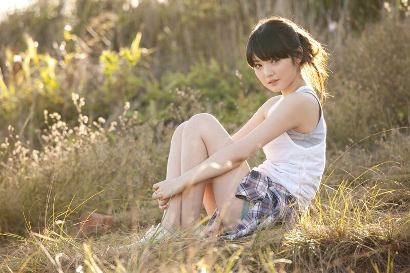 girl sitting in a field