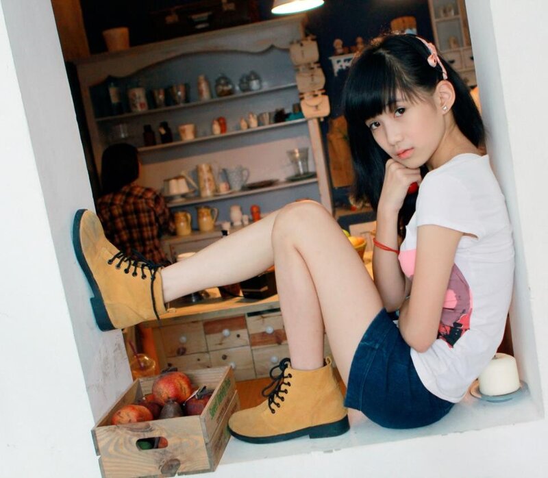 girl sitting in a kitchen nook