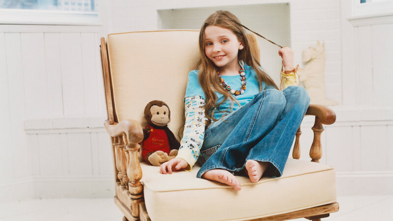 Girl Sitting in Armchair