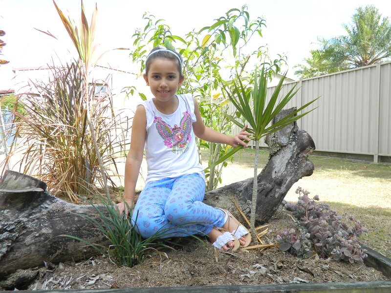 Girl Sitting in Garden — Blue