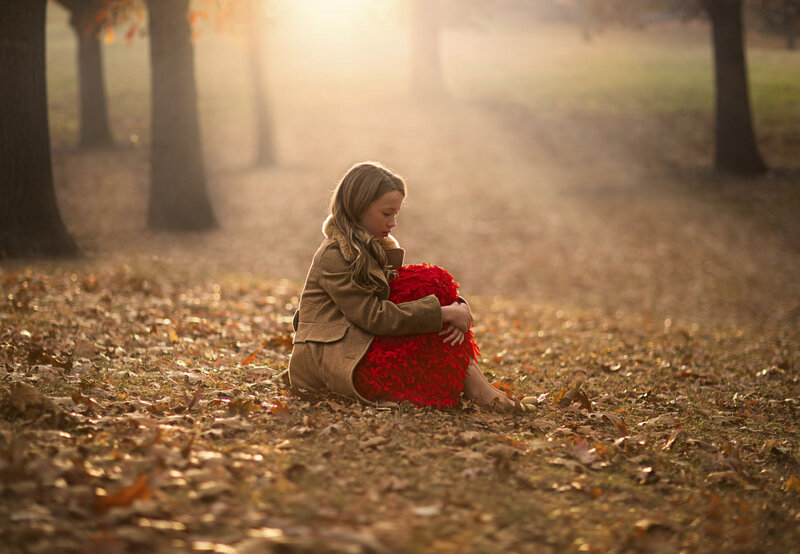 Girl Sitting in Leaves