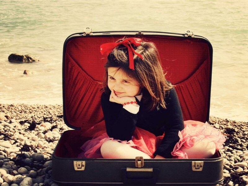 Girl Sitting in Suitcase