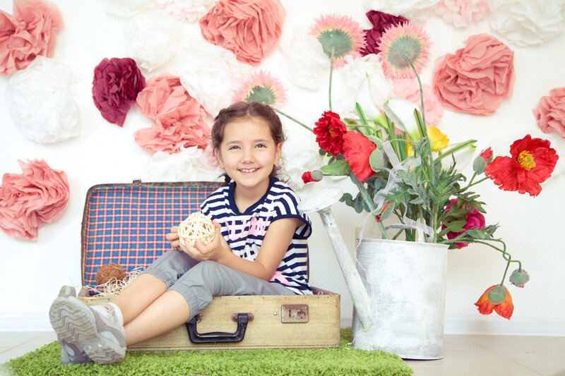Girl Sitting in Suitcase — White