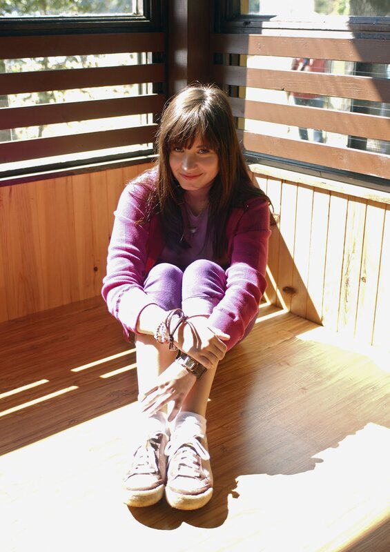 Girl sitting in sunlit room