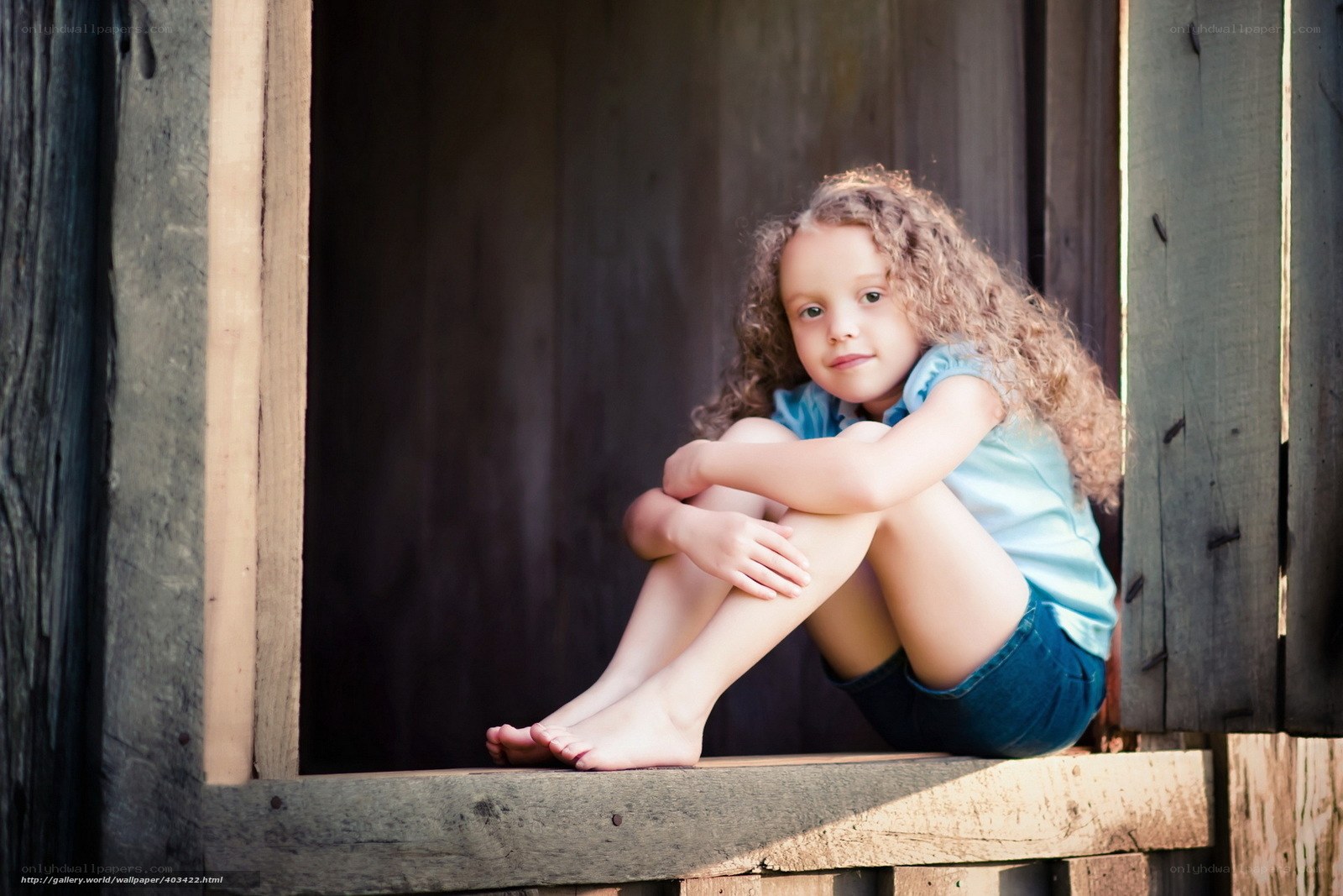girl sitting in wooden window