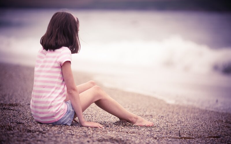 Girl sitting on a beach