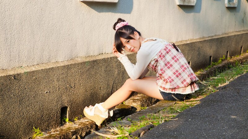 girl sitting on a curb