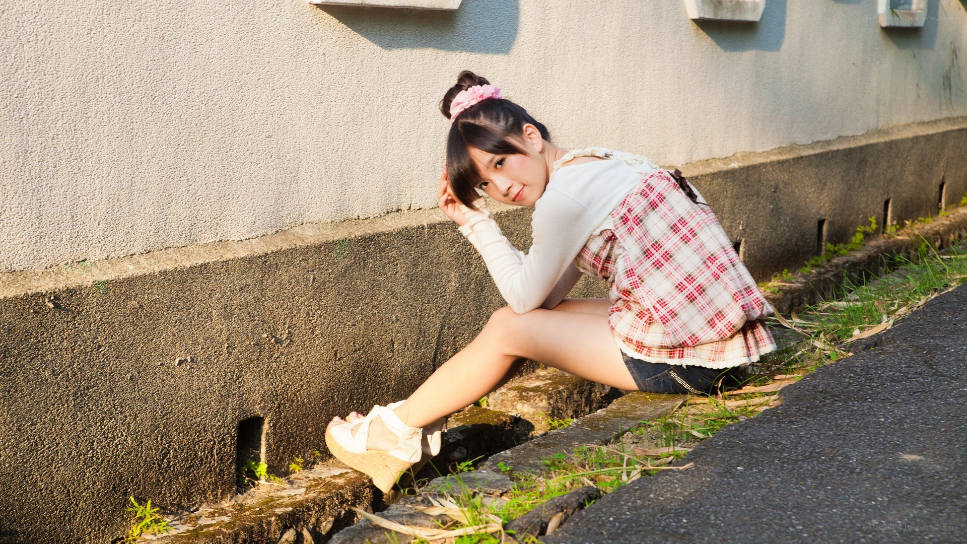 girl sitting on a curb