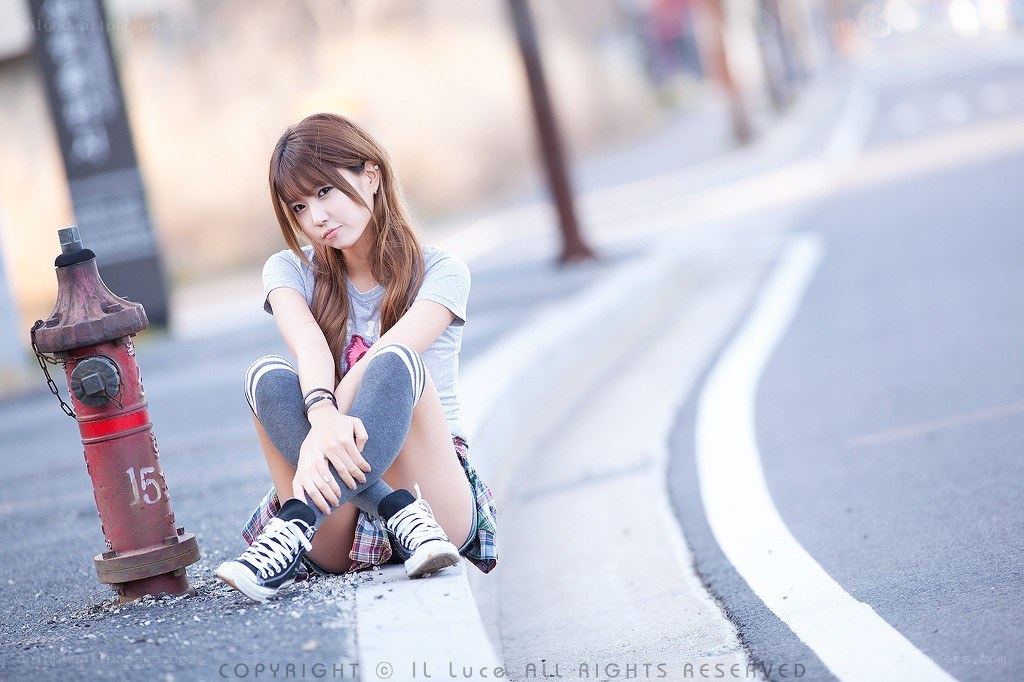 Girl sitting on a curb
