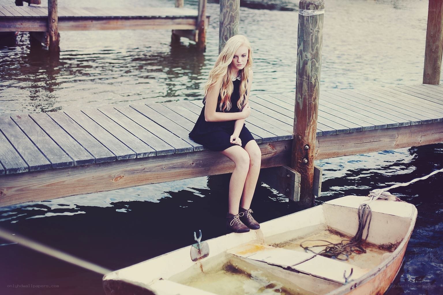 Girl sitting on a dock