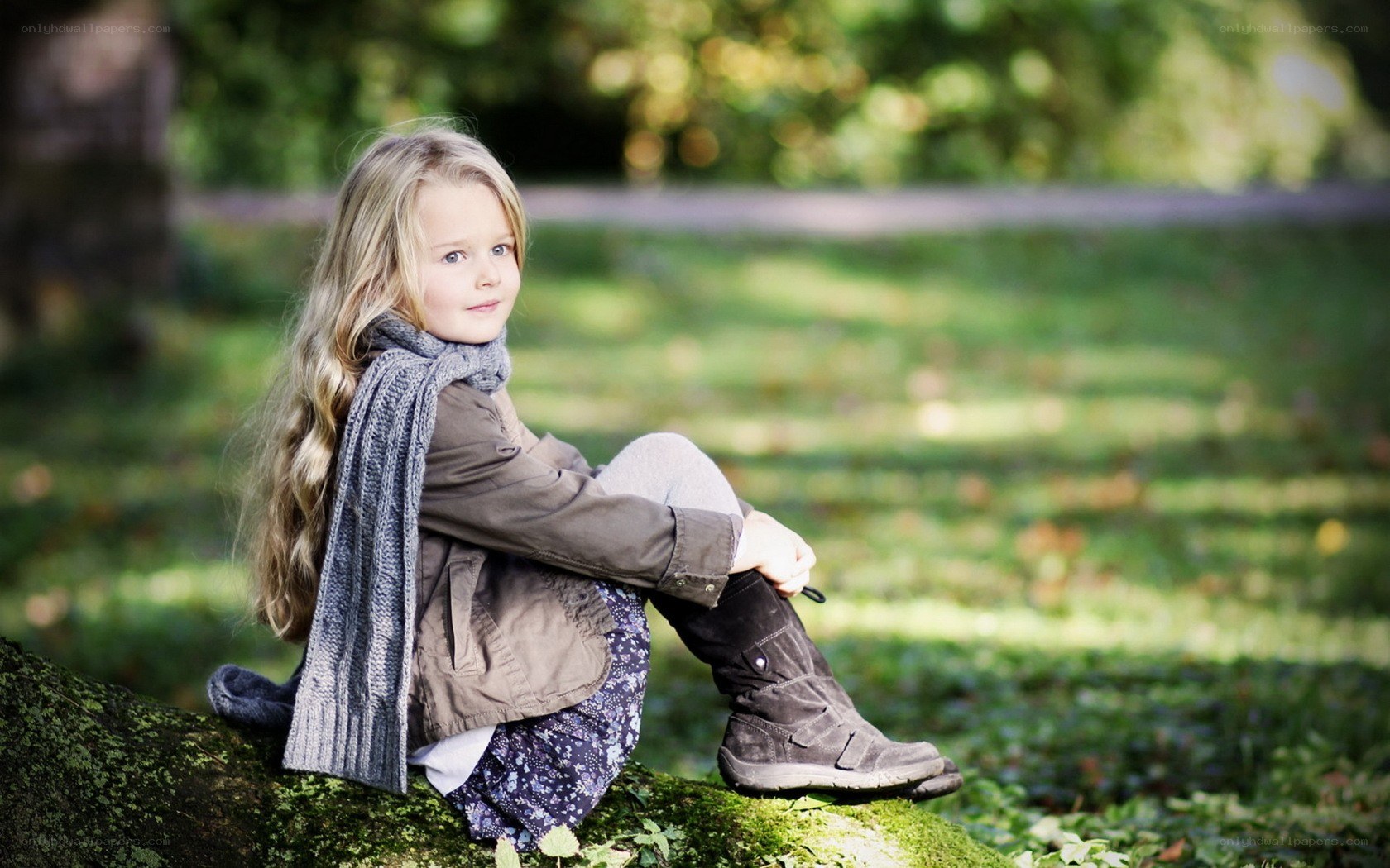 girl sitting on a log