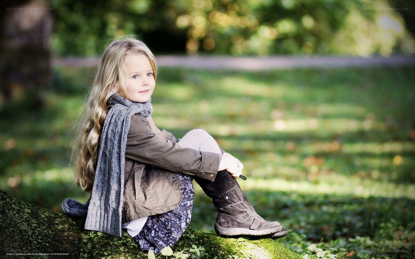 Girl sitting on a mossy log
