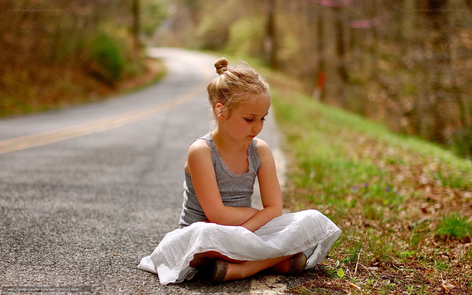 Girl sitting on a road