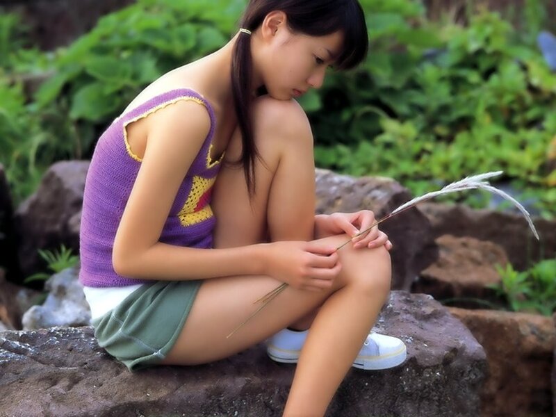 Girl sitting on a rock